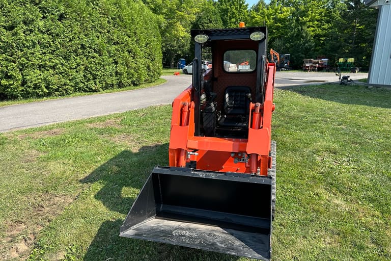 TK35 compact track loader front view, bucket on the ground